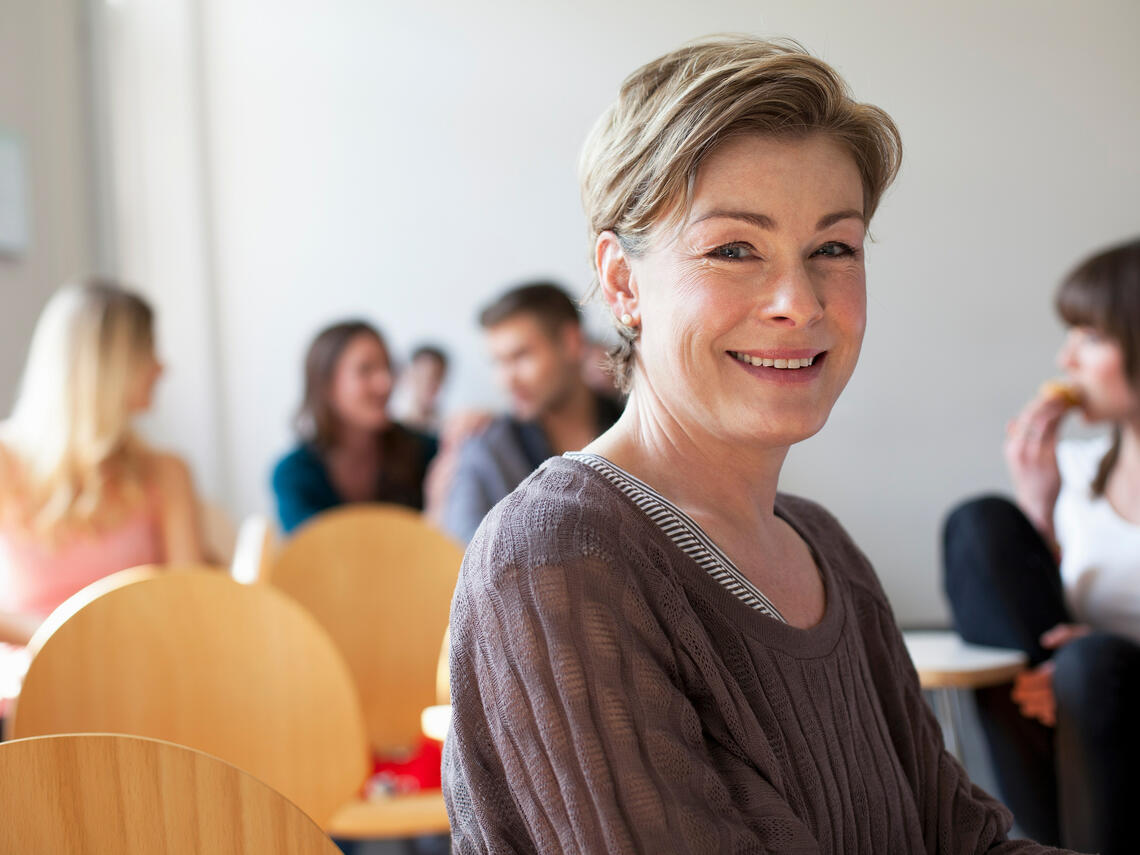 Older student smiling in class room